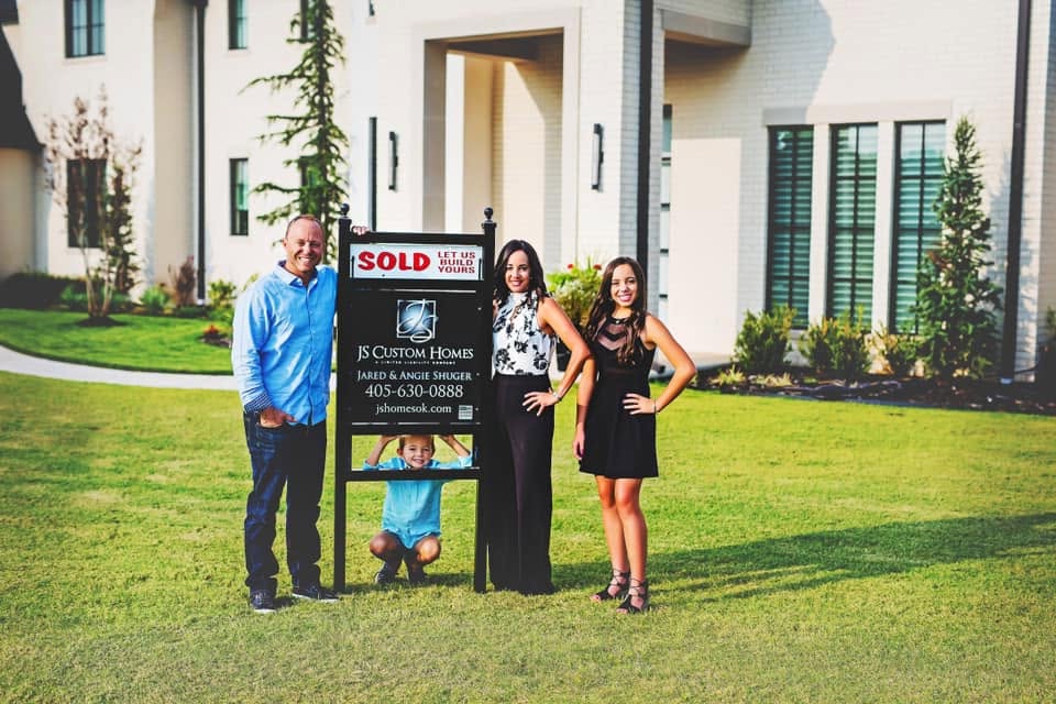 Jared and Angie Shuger with their family in front of a JS Custom Home